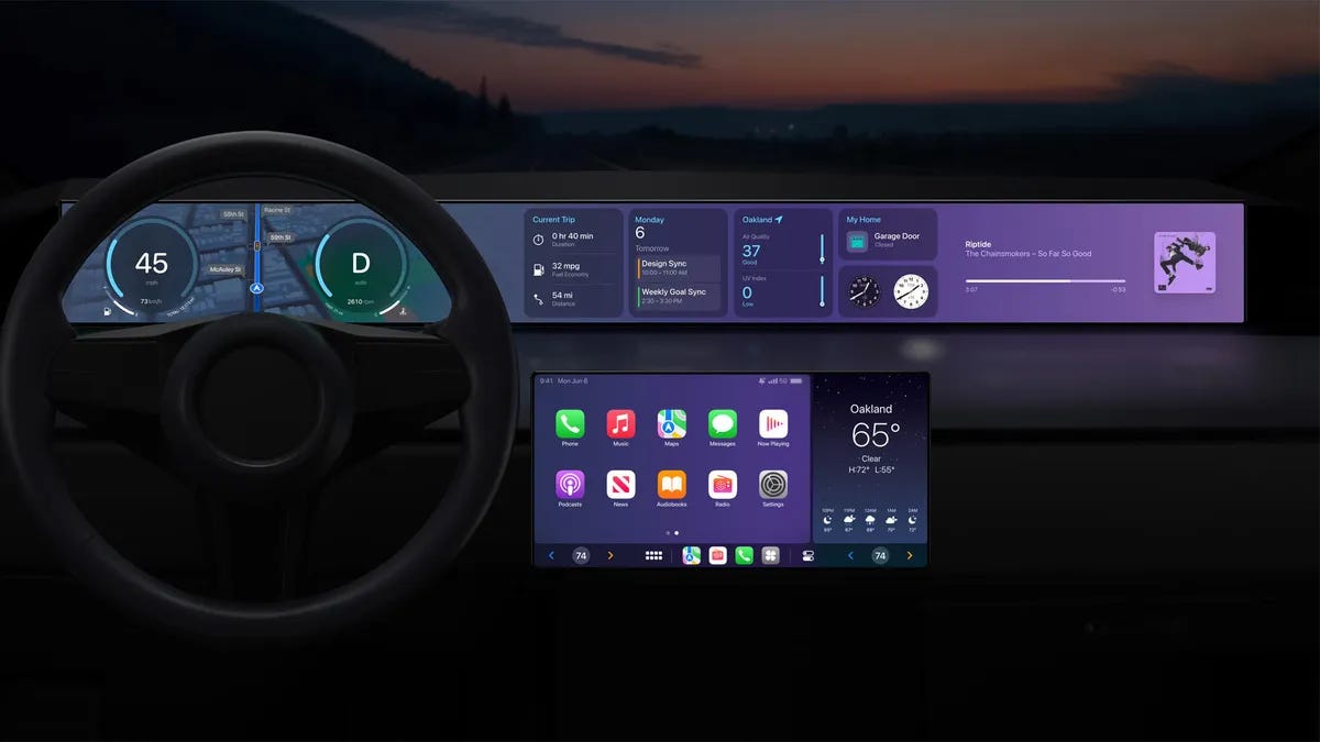 A vehicle dashboard showing a screen in the center console and another going from one end of the dashboard to the other, filled with apps and widgets you’d see on an iPhone.