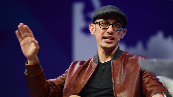 Shopify CEO Tobi Lutke seated on stage at a conference